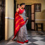 Black and white Bishnupuri silk saree with red, dark pink and orange striped Pallu and border